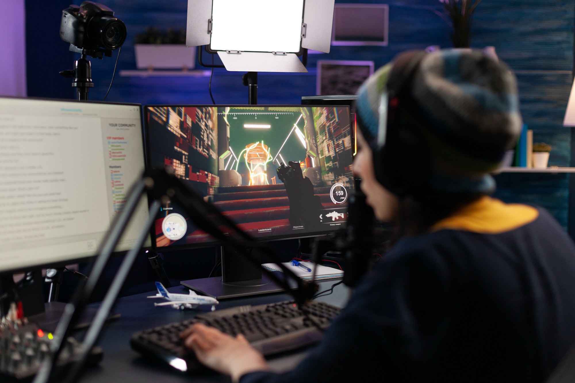 Woman live streaming video games on monitor with chat